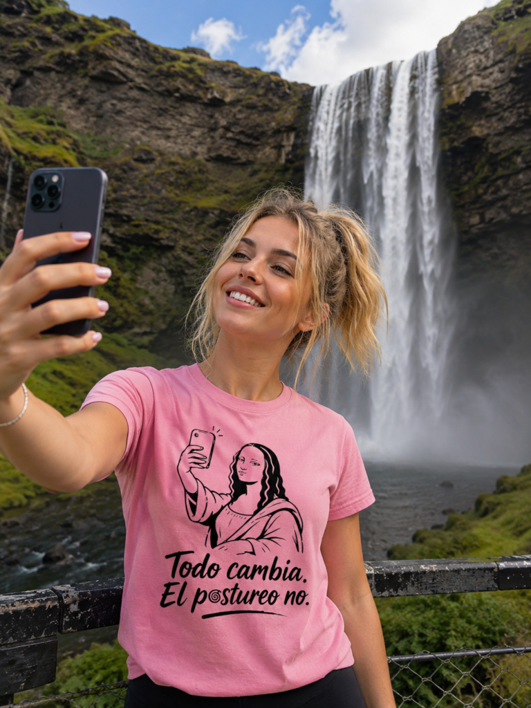 Una chica rubia se hace un selfi delante de una catarata. LLeva puesto auna camiseta de "Todo cambia. El postureo no"
